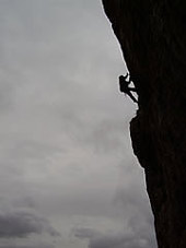 Climbing steep rock at Dusk